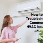 Woman holds her hand under her HVAC vent to test it