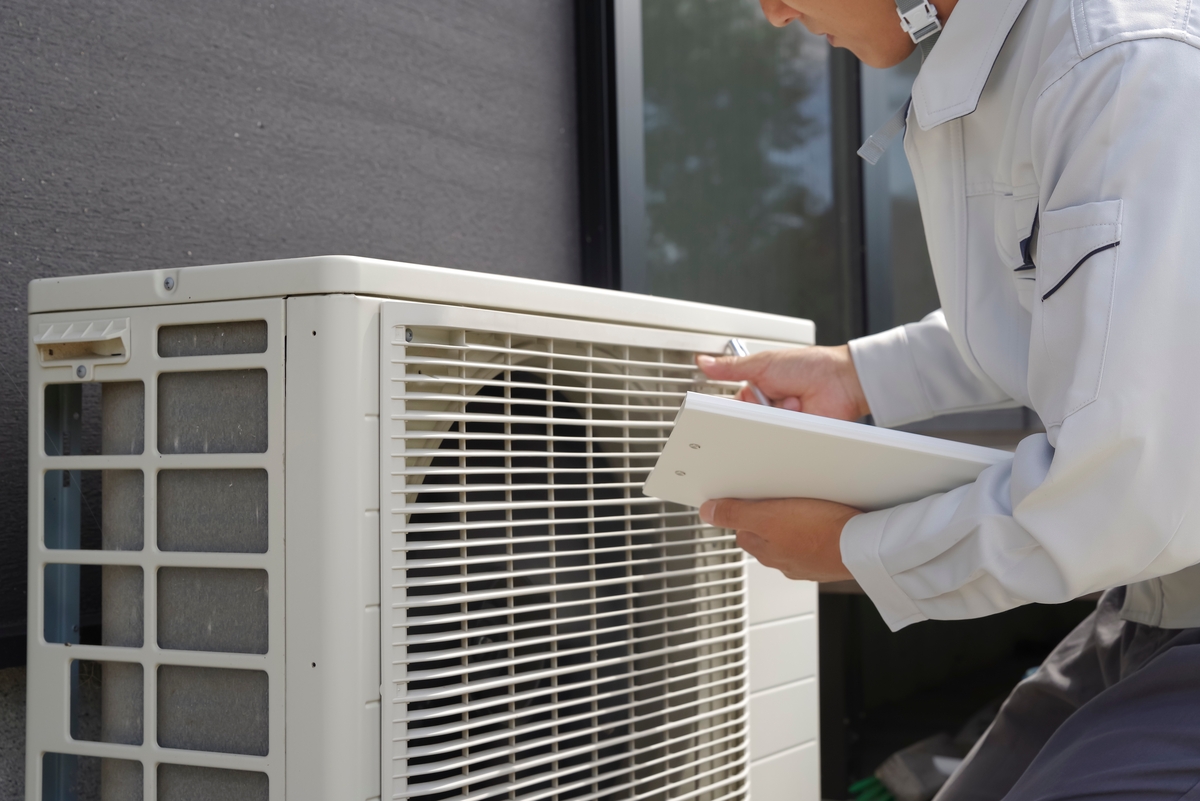 A,Man,Checking,The,Outdoor,Unit,Of,The,Air,Conditioner